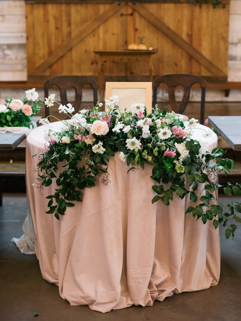 soft blush sweetheart table with cascading floral decor