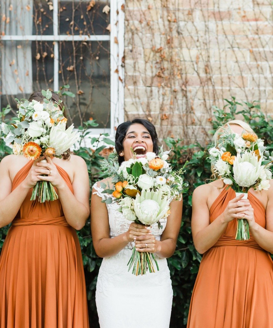 bride and her bridesmaids rocking burnt orange twist wrap dresses