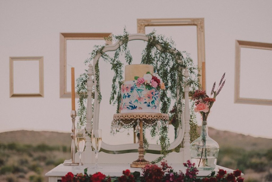Floral wedding cake display with vintage mirror frames