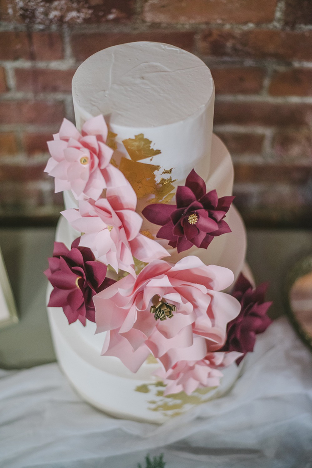 paper flower accented wedding cake