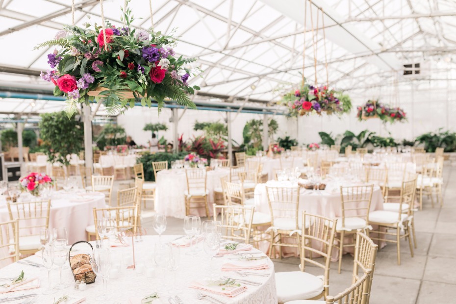 gold and white wedding reception in a giant greenhouse