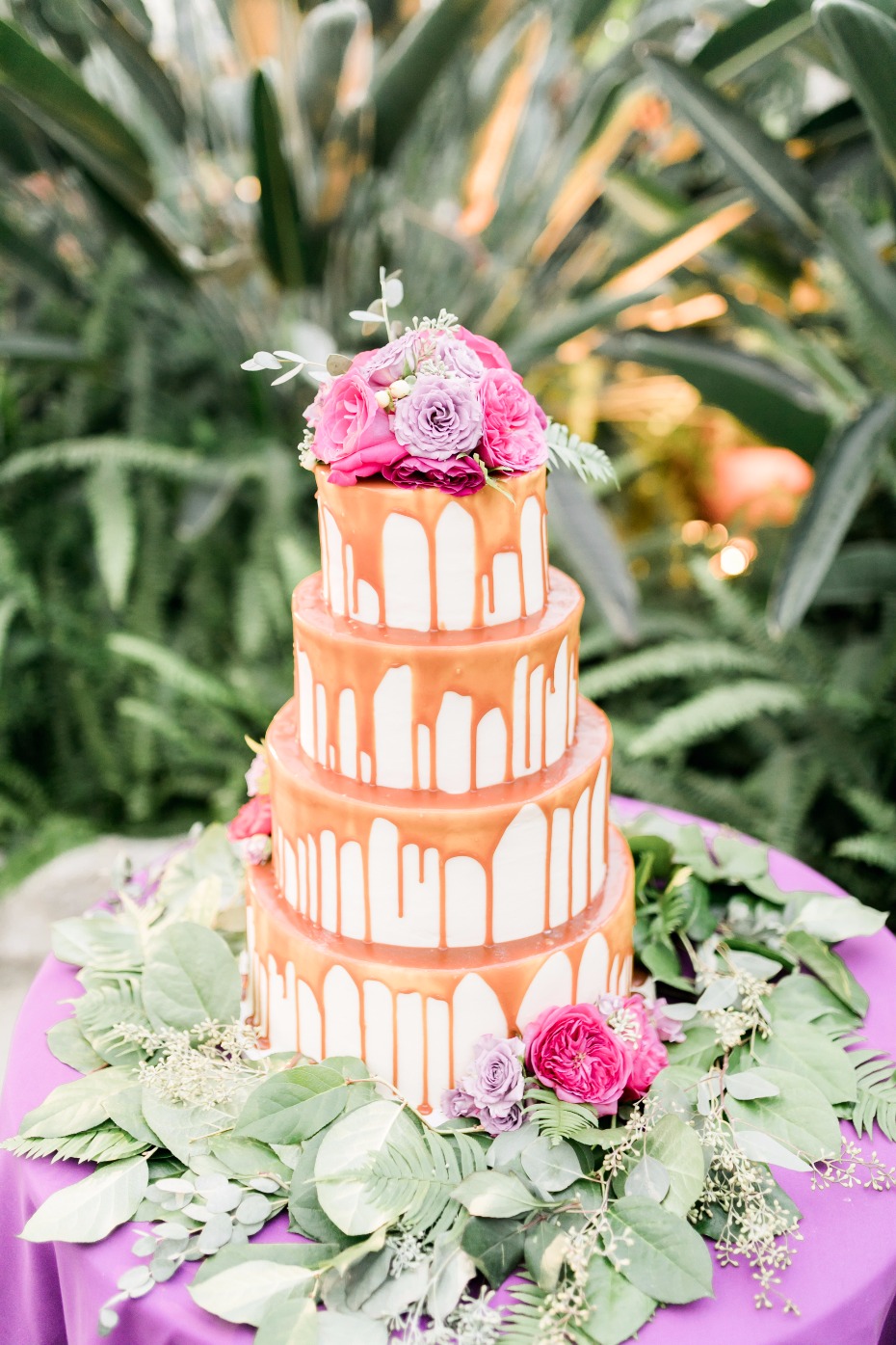 caramel drizzle wedding cake topped with flowers