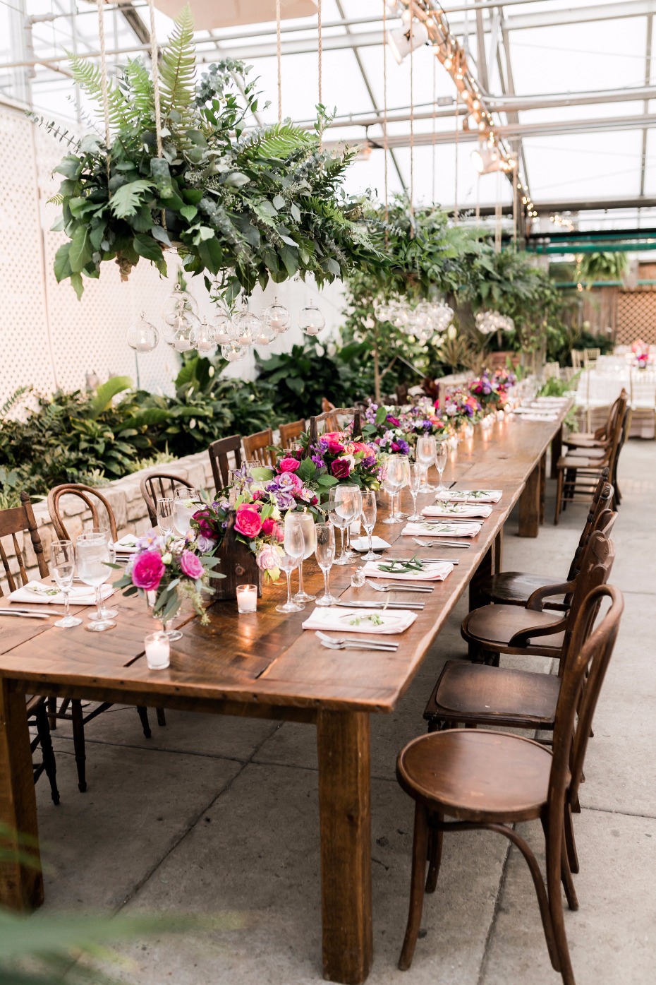 farm table chic family style wedding decor in a giant greenhouse
