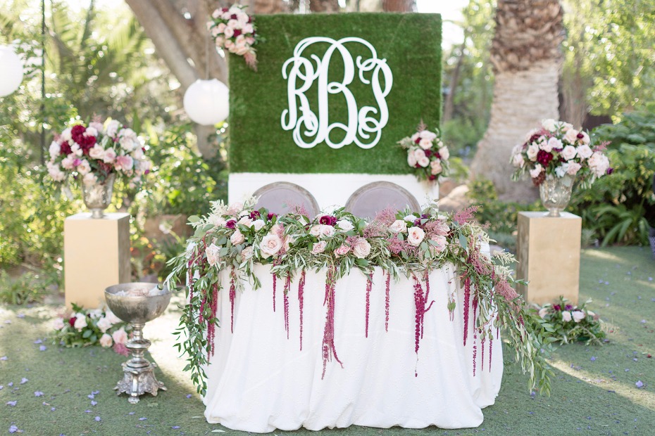 Sweetheart table with monogrammed backdrop