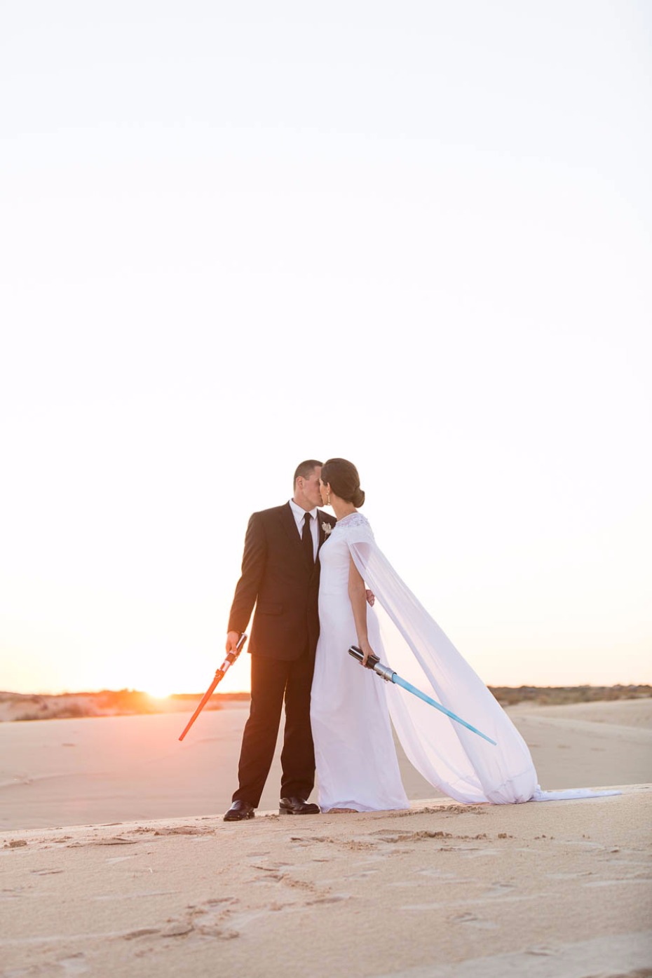 two Jedi share a kiss just as the sun sets on this Star Wars wedding