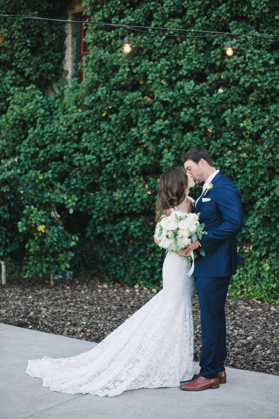wedding couple in glamorous Inbal Dror gown and navy suite