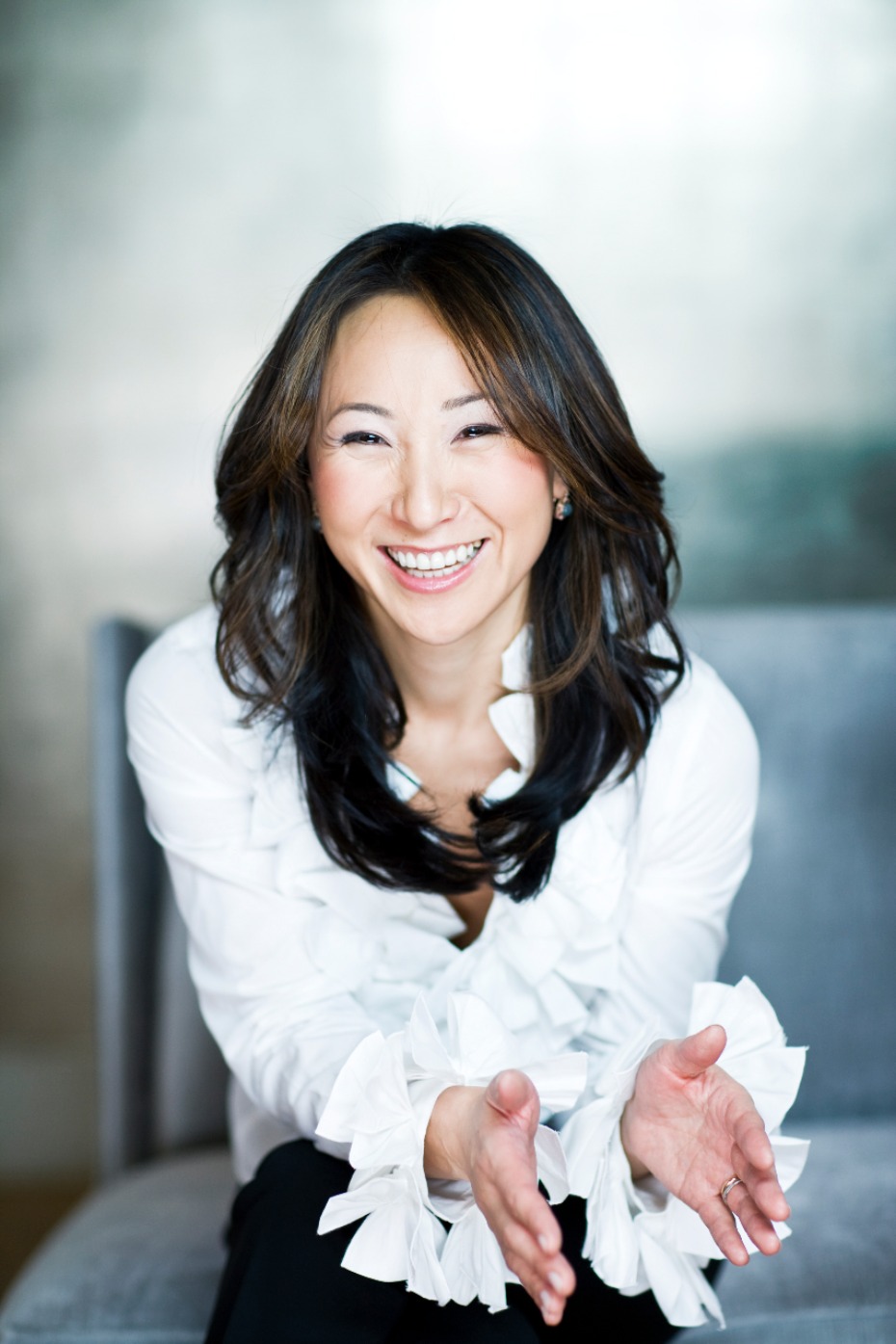Happy businesswoman in white blouse, welcoming gesture