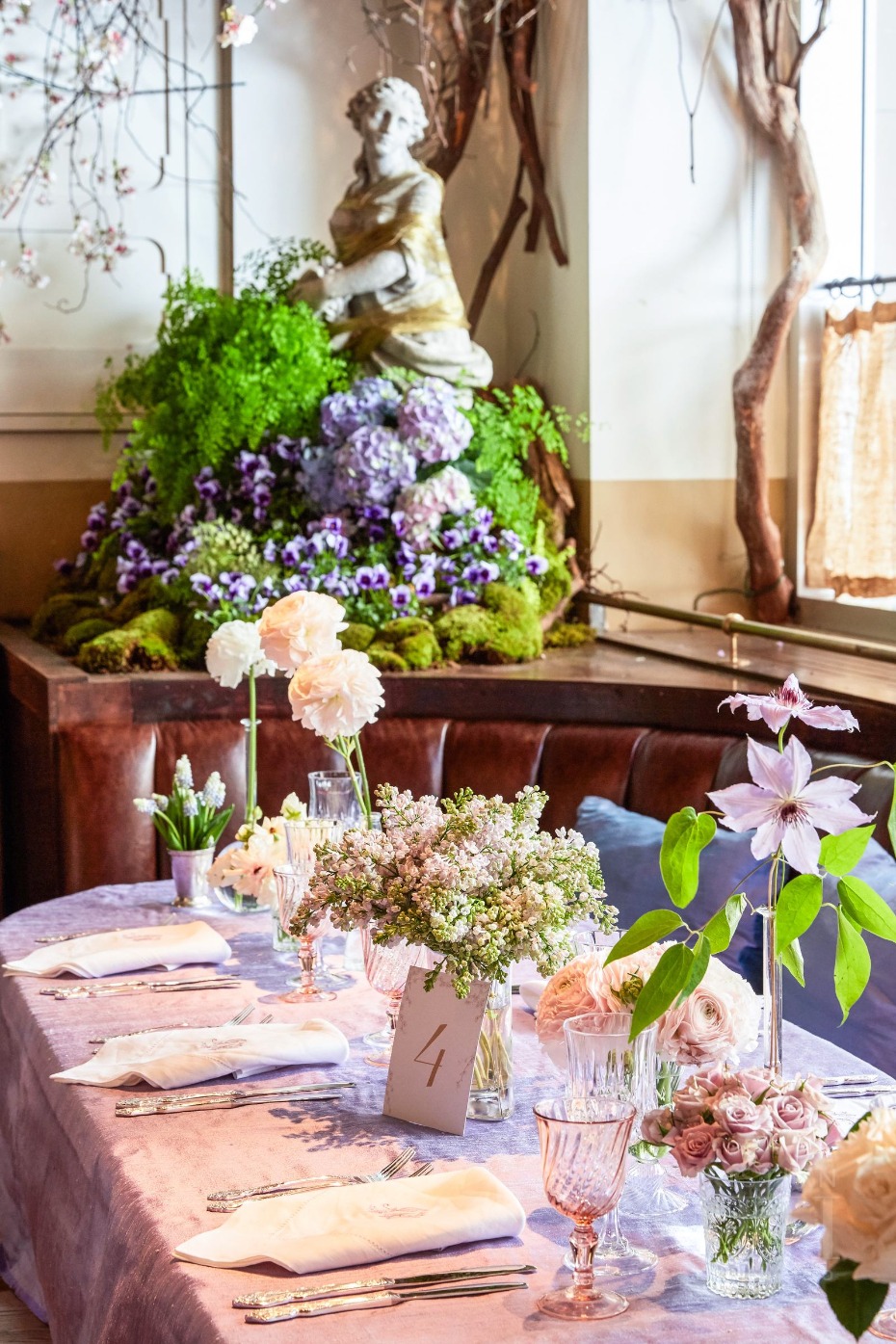 Elegant table setting with floral arrangements and statue