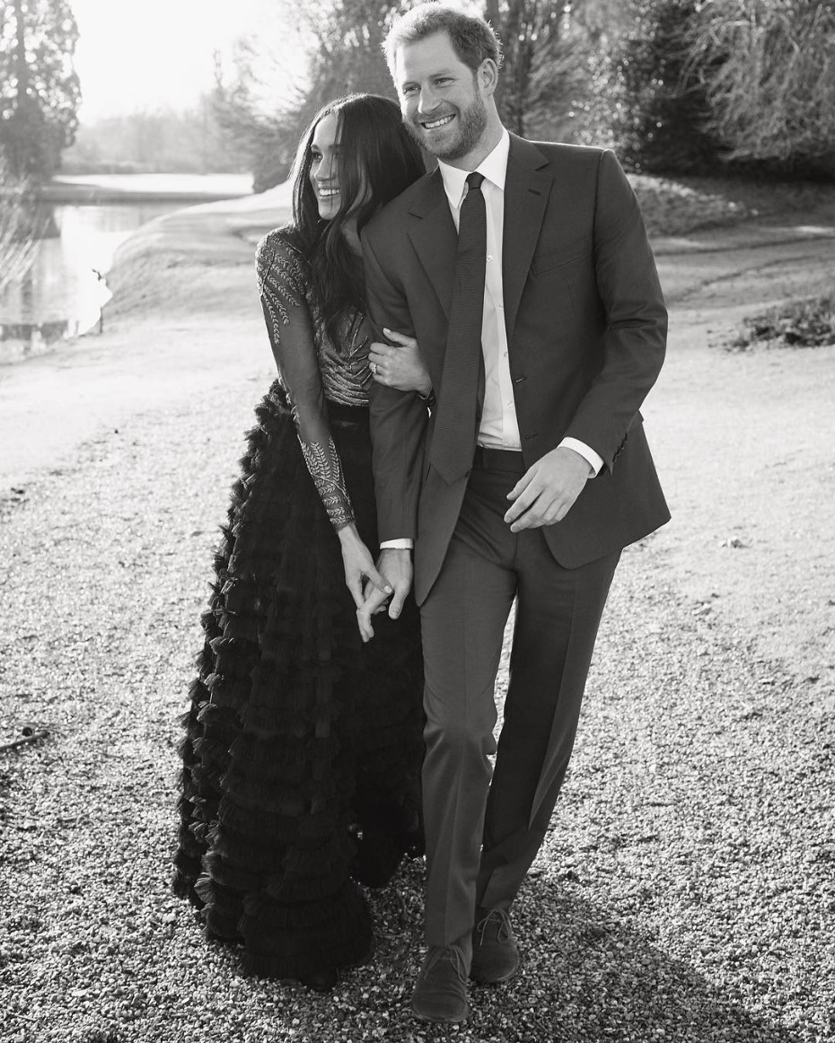 Harry and Meghan walking holding hands black and white