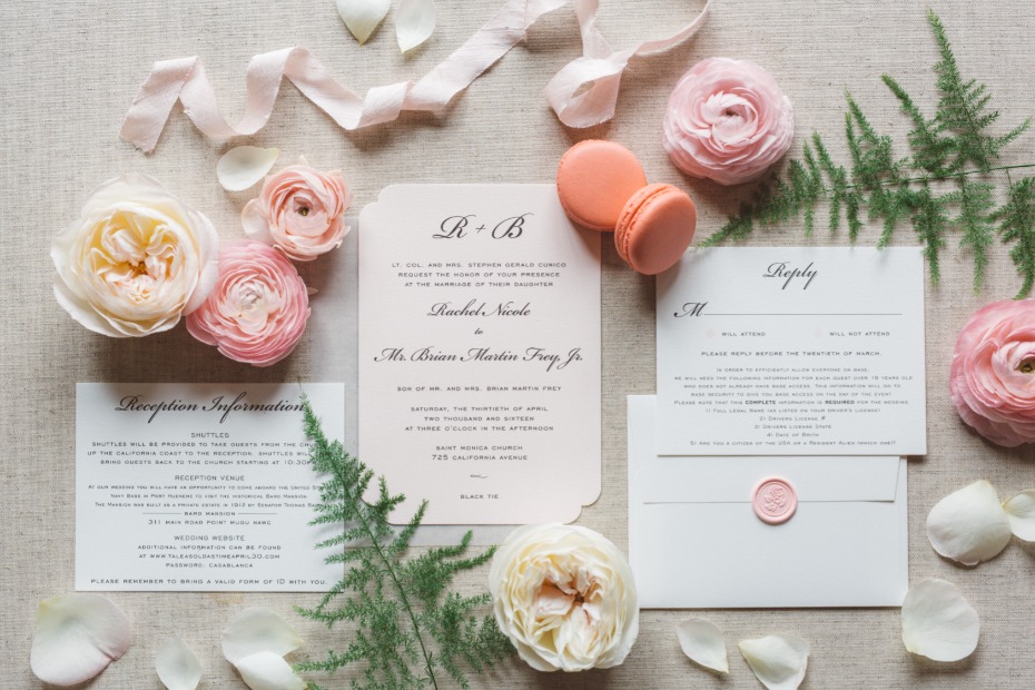 Elegant wedding invitation suite with flowers and macarons