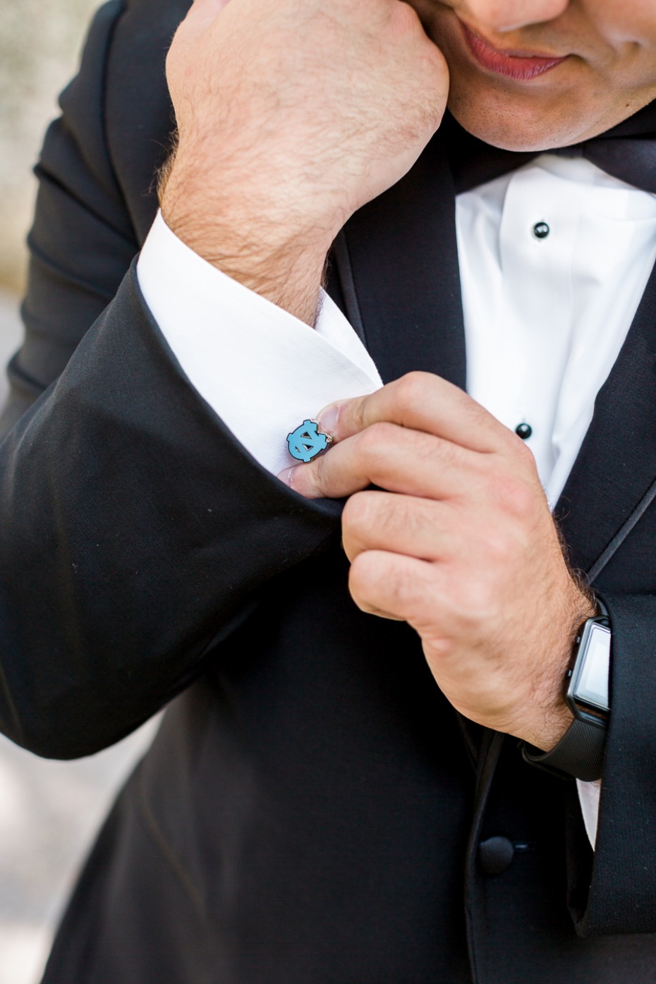 groom sporting his favorite team on his cuff links