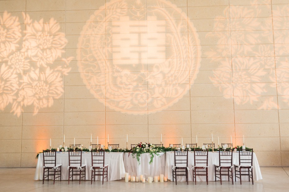 wedding party table with Chinese symbol for marriage projected behind it