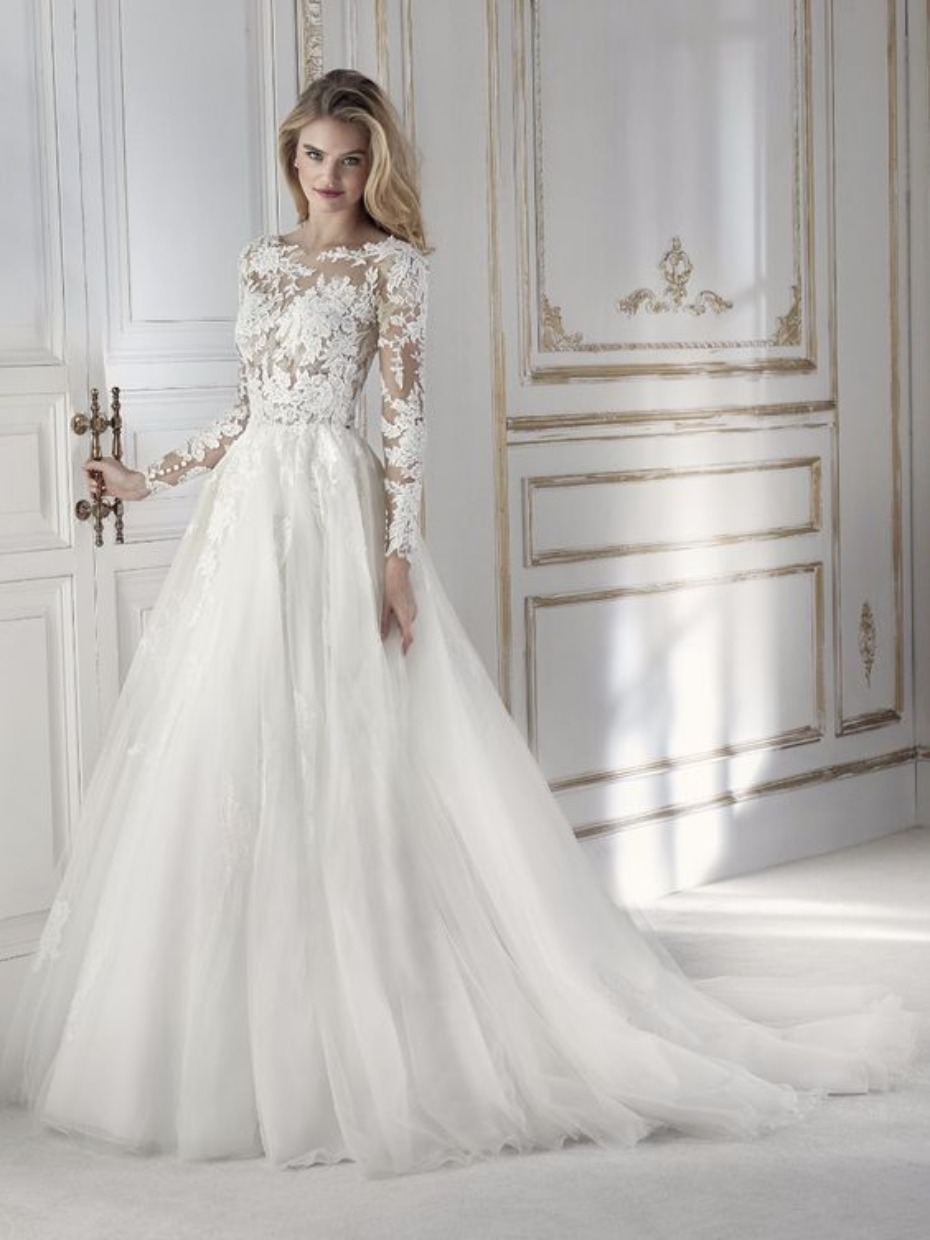 Elegant blonde bride wears lace long sleeve wedding gown