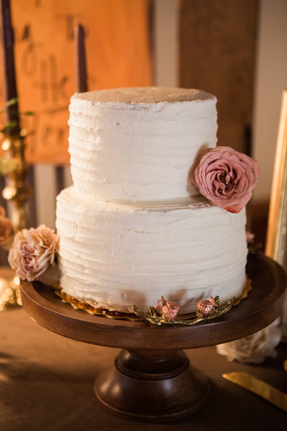 classic white wedding cake with rose accents
