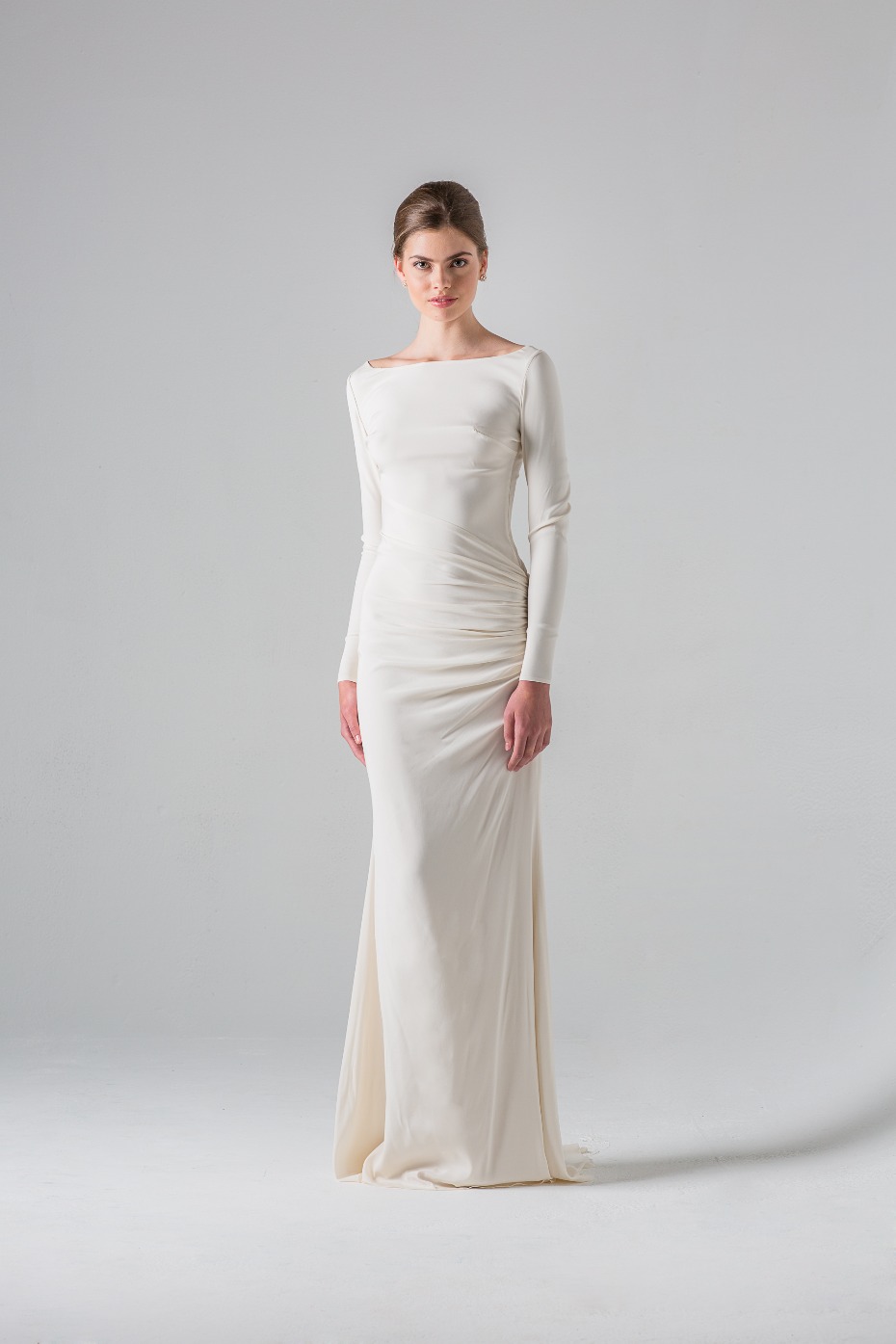 Elegant woman wearing a long sleeved white wedding dress