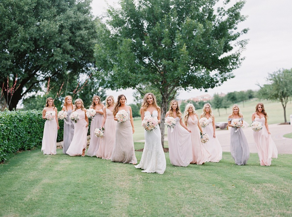 bride and all her bridesmaids in mix and match pastel dresses