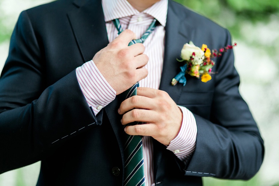 groom in red and green stripes with a modern cut navy suit