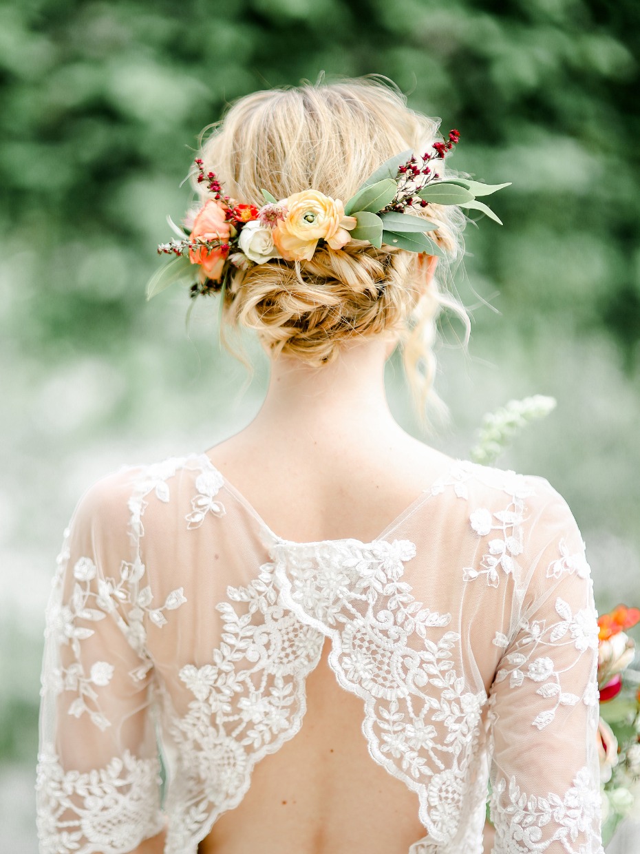wedding updo with bright floral accents
