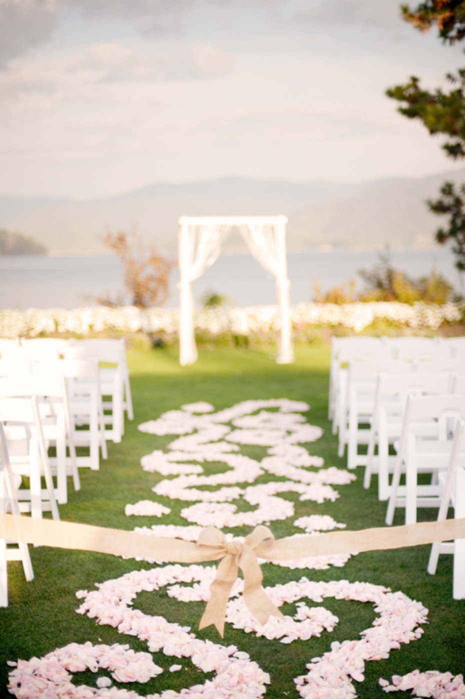 Romantic outdoor wedding aisle with flower petals