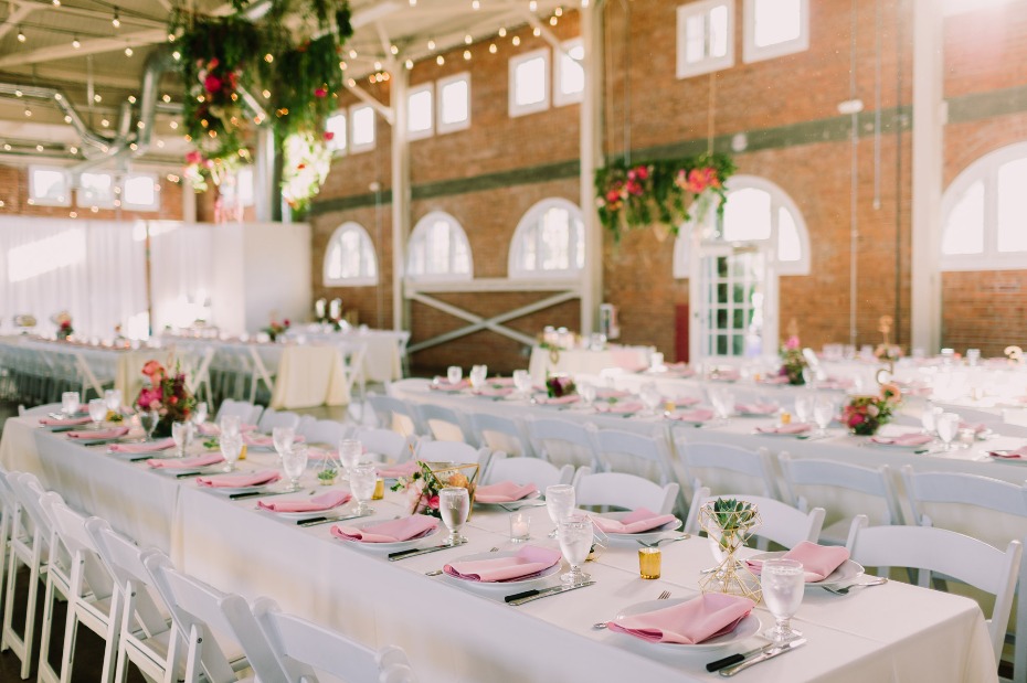 Cheerful reception space with pink and white linens