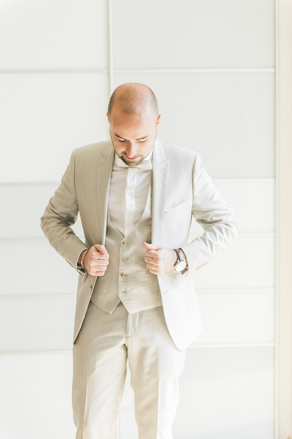 groom in sand colored wedding suit