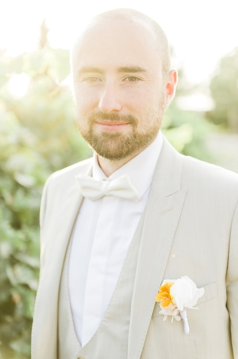 handsome groom in sand colored wedding suit