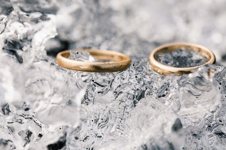 Wedding rings on ice, symbolizing a cold beginning