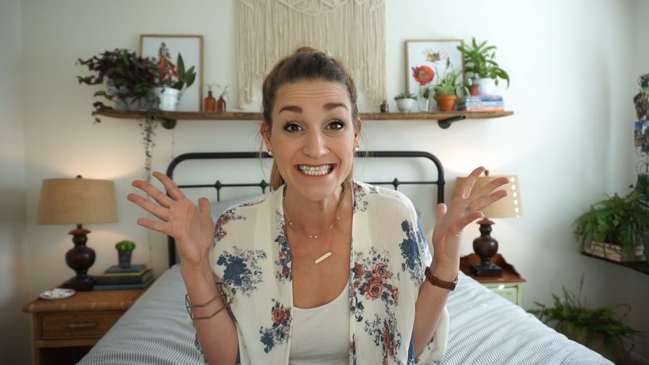 Enthusiastic woman in bedroom with plant decorations