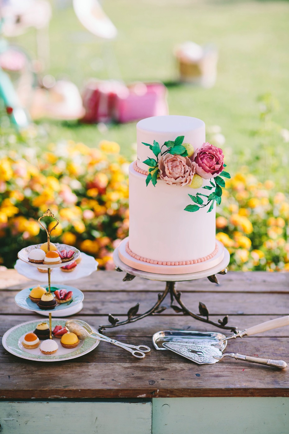 Floral accented wedding cake with tasty pastries