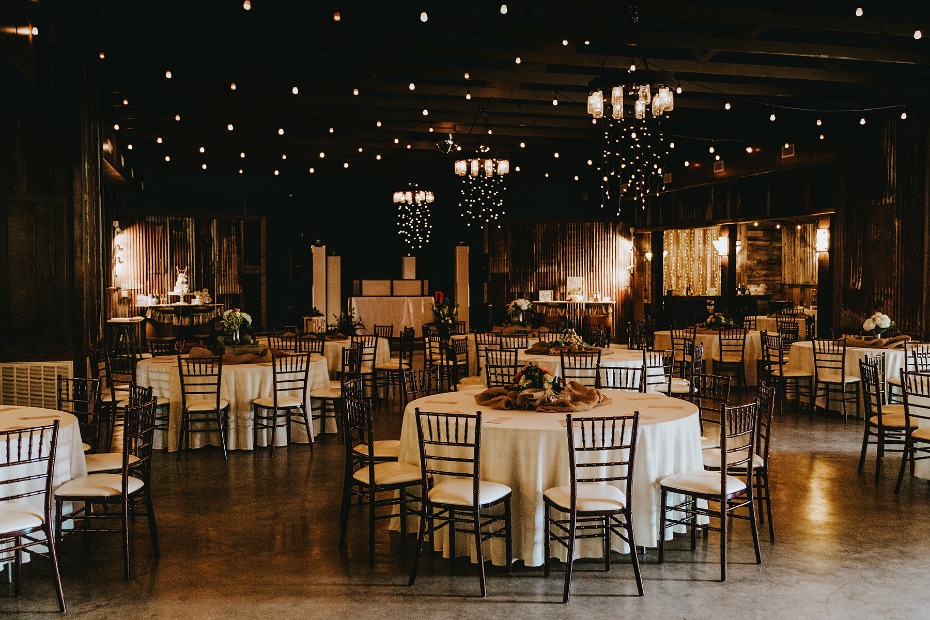 Rustic barn reception with bistro lighting