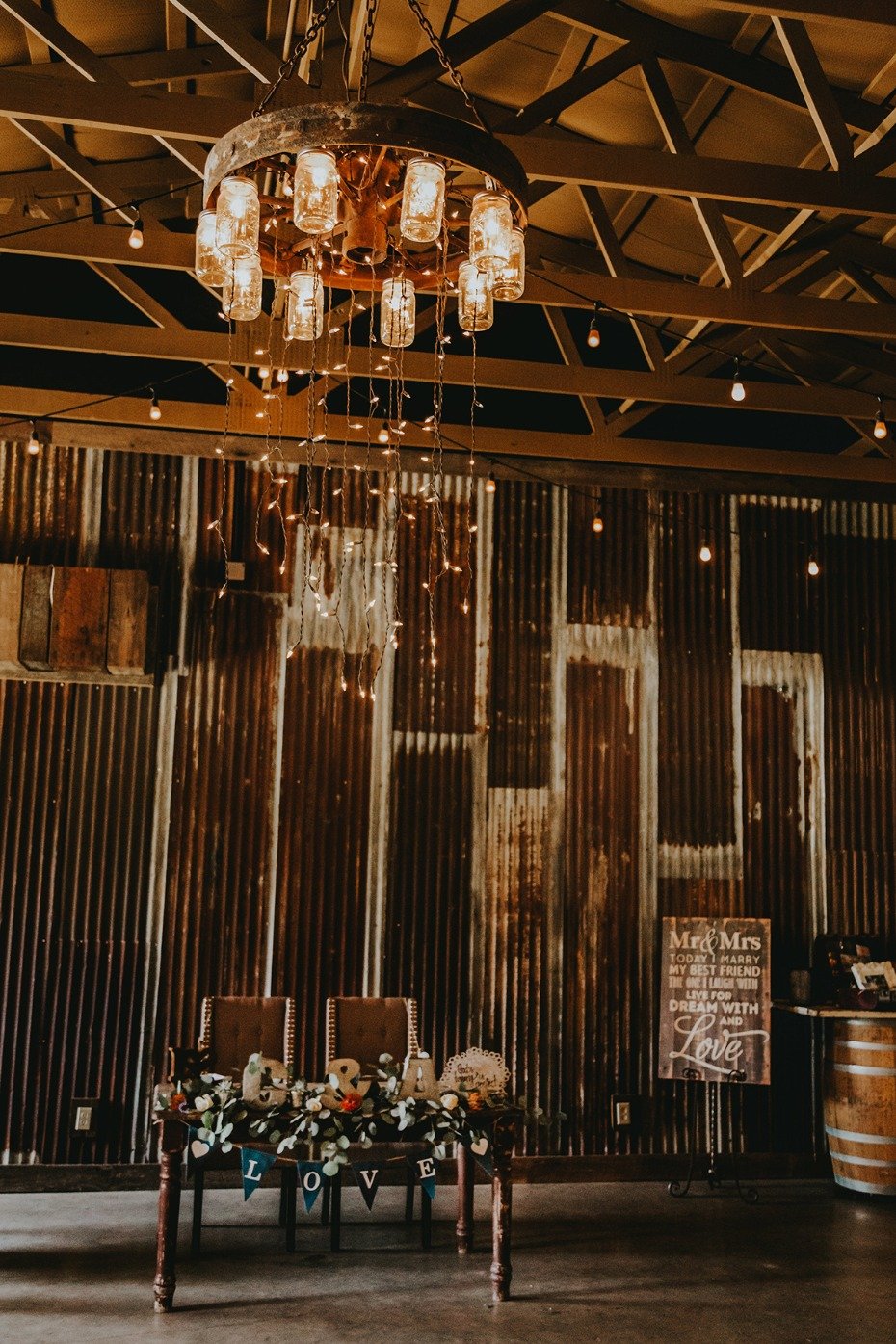 Rustic sweetheart table with a mason jar chandelier