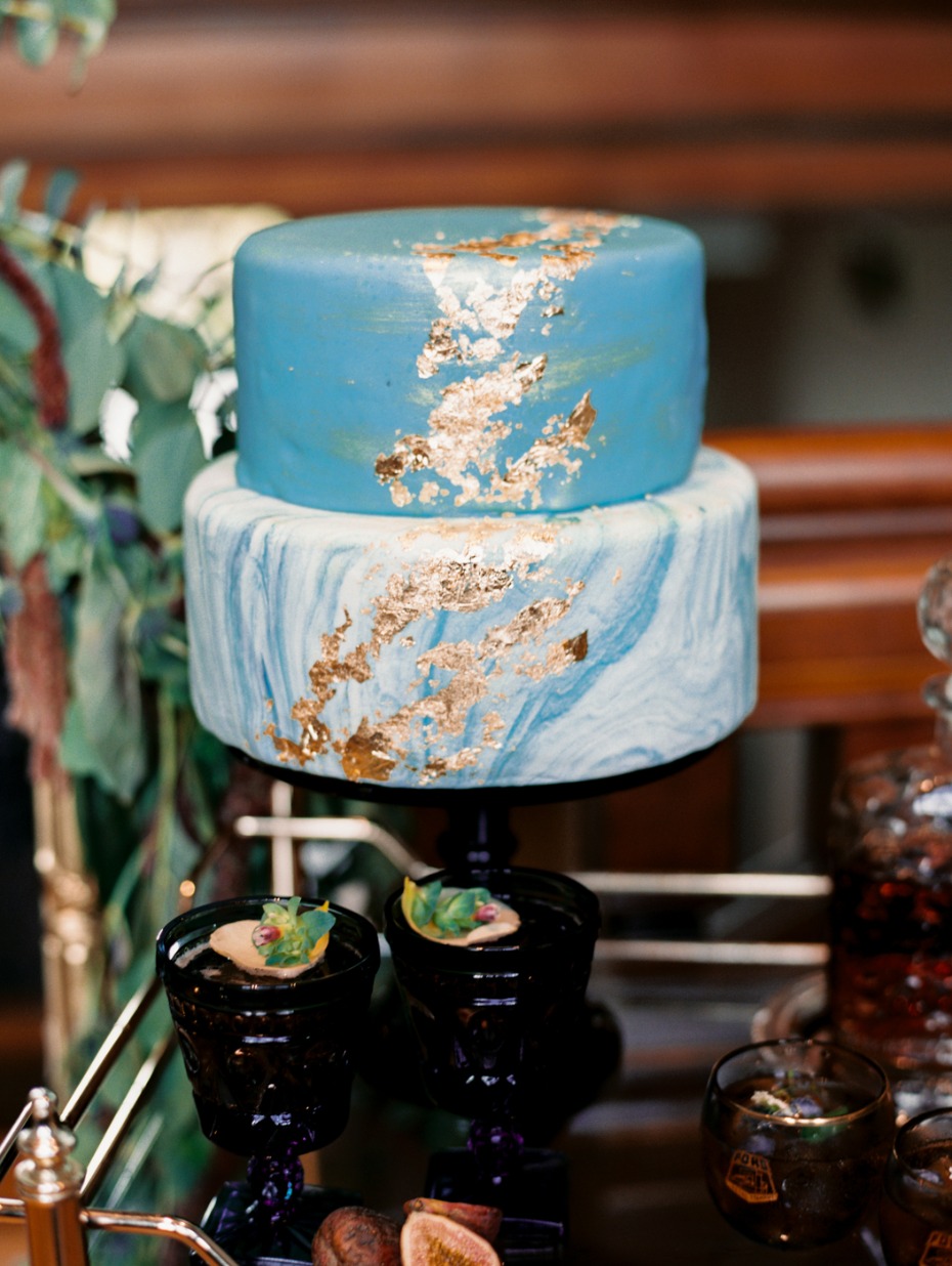 light blue marbled wedding cake with gold leaf accents