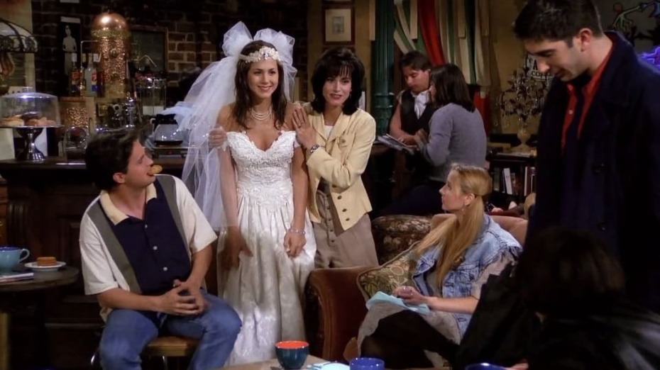 Rachel in wedding dress with friends in Central Perk cafe