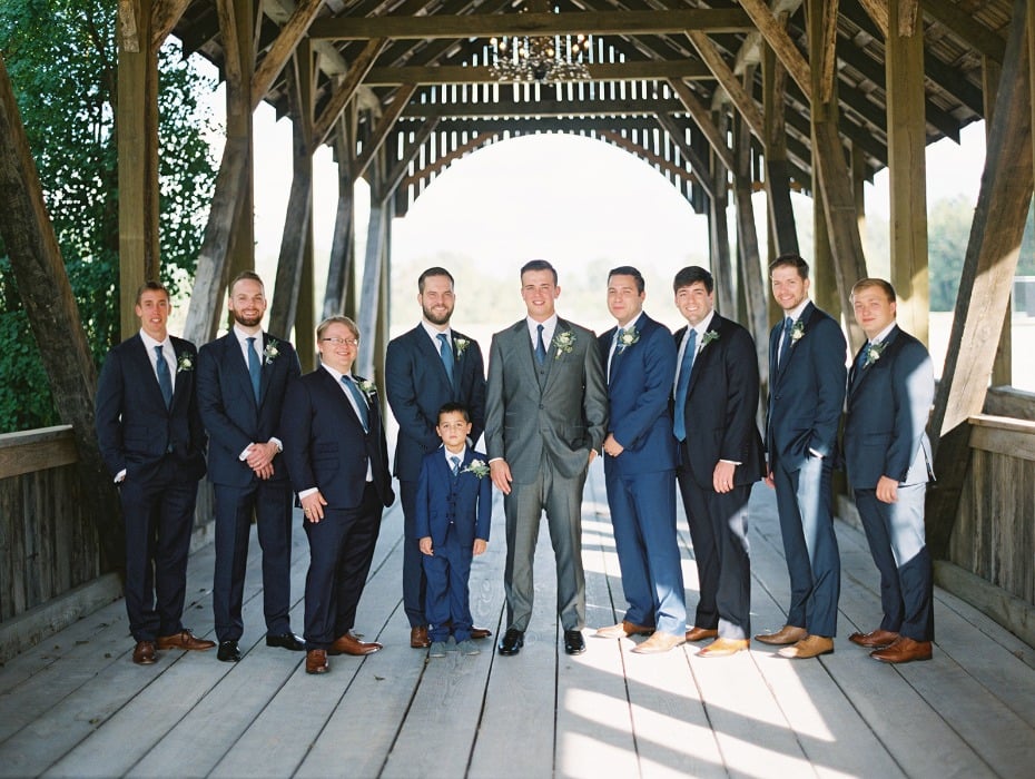 groom in silver grey suit and groomsmen in navy