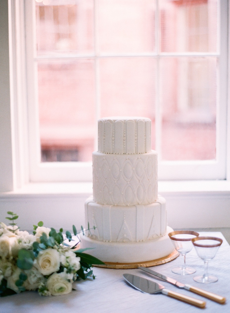all white wedding cake with unique frosting textures