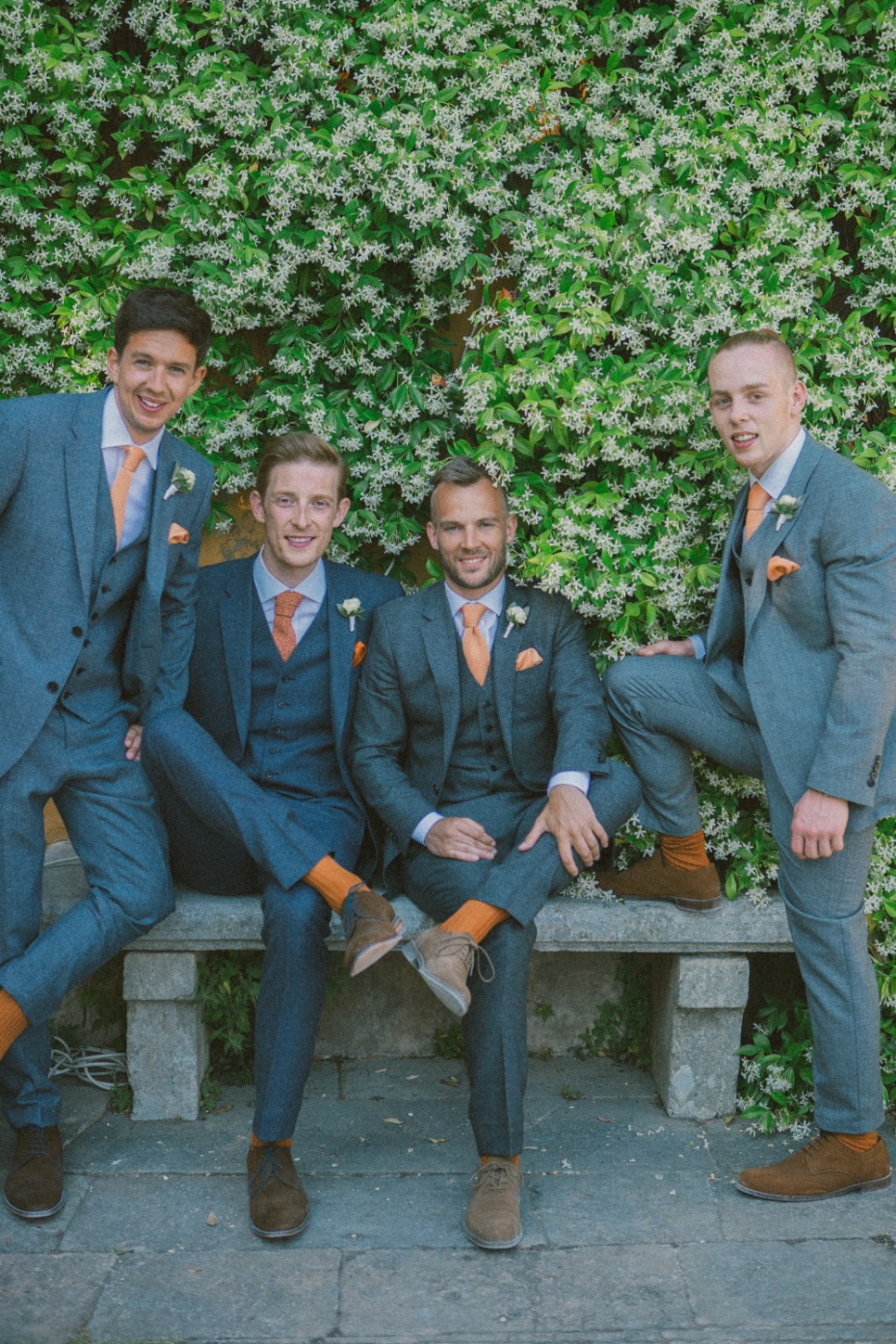 Grey and orange groomsman suits