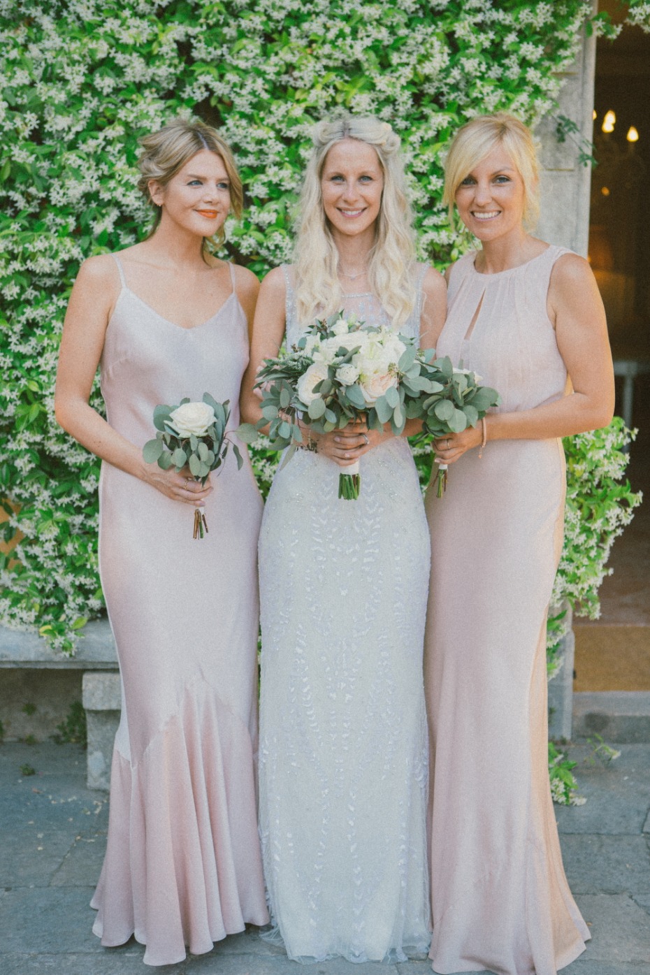 Bride and bridesmaids in blush wedding dress