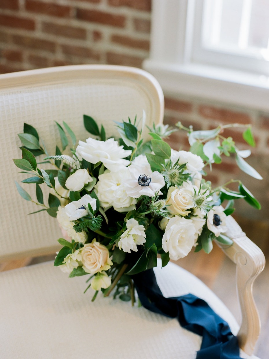 White and green bouquet with navy ribbons