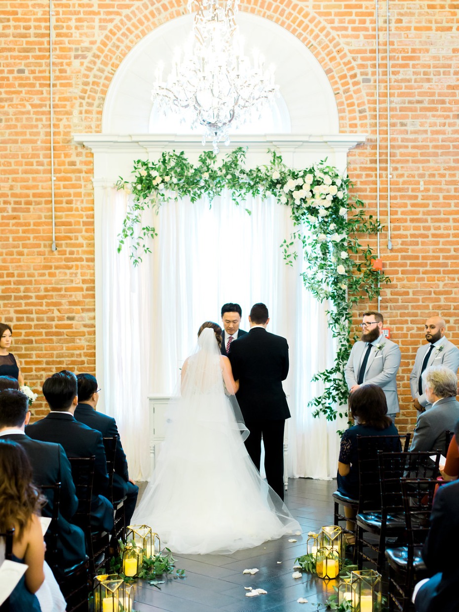 Chic ceremony with chandelier and brick