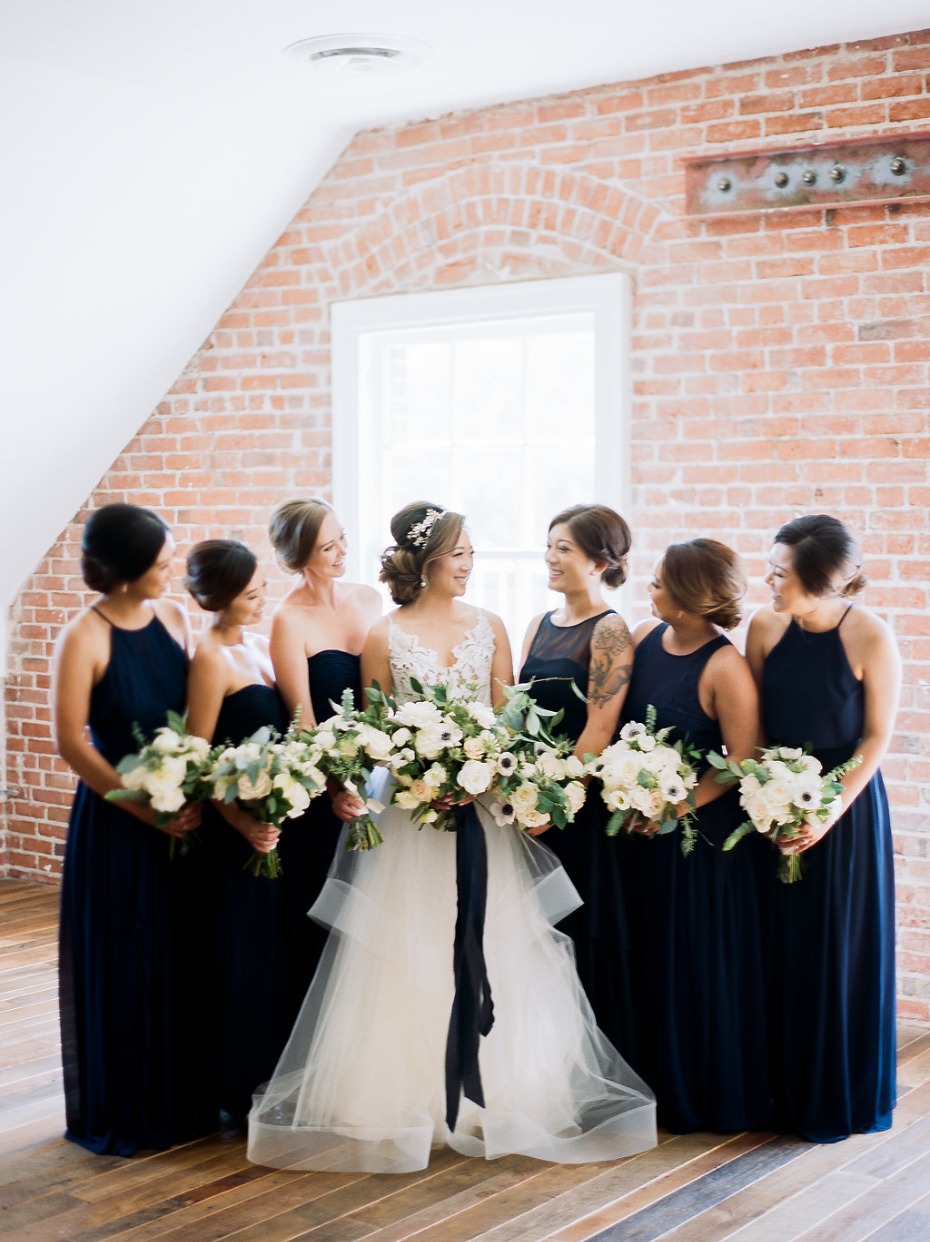 Bridesmaids in mismatched navy dresses