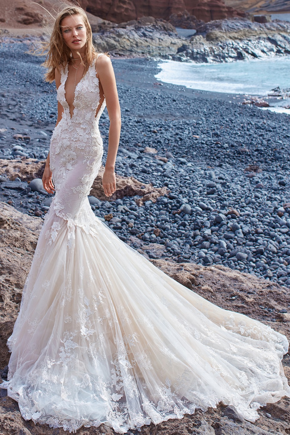 Stunning lace mermaid wedding gown on beach