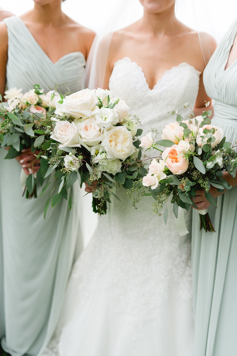 soft mint bridesmaid dresses with peach and white bouquets