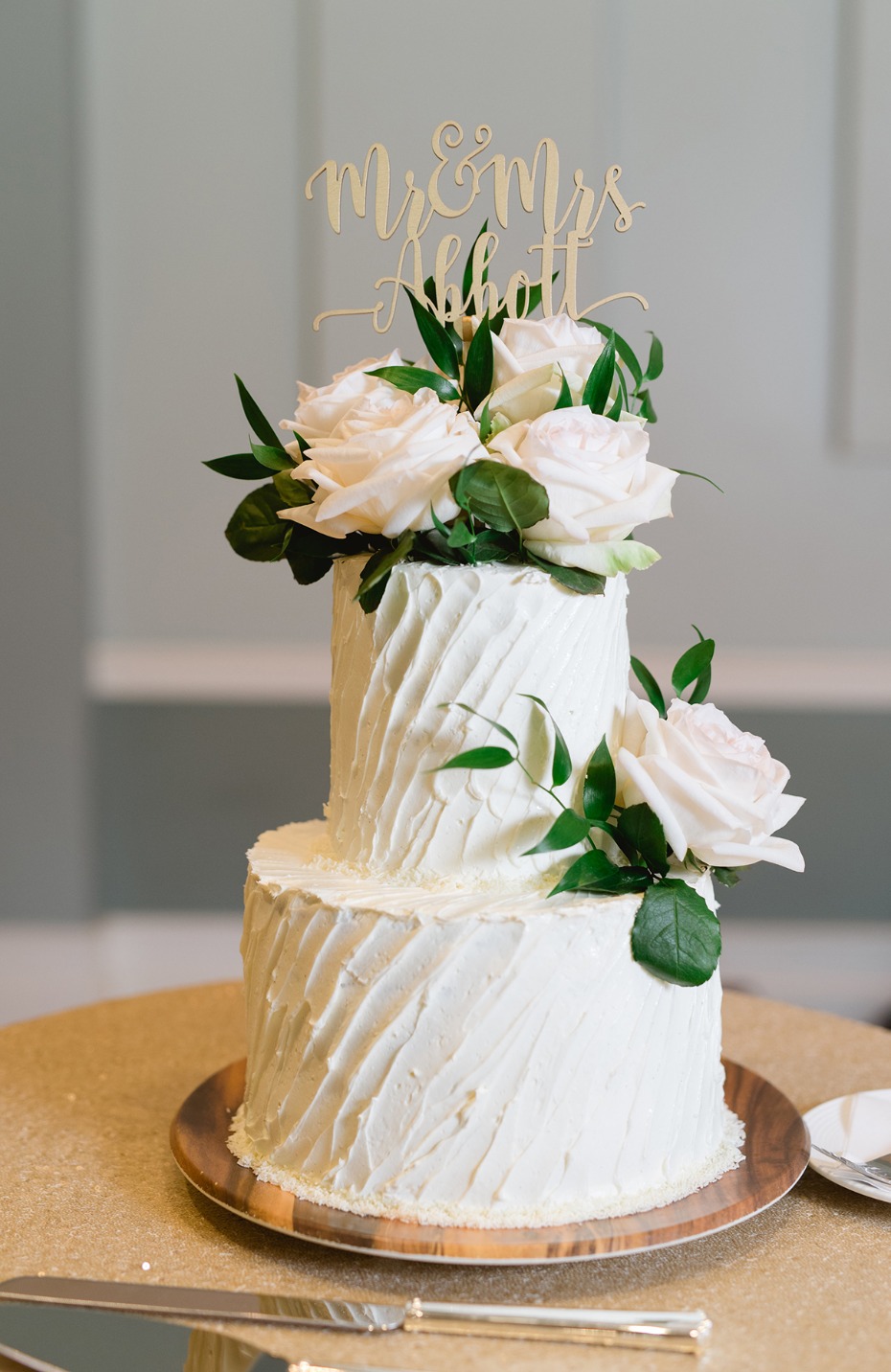 romantic classic white wedding cake topped with white roses