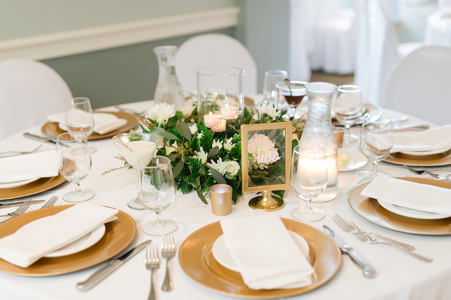 gold and white wedding table decor with clear table number