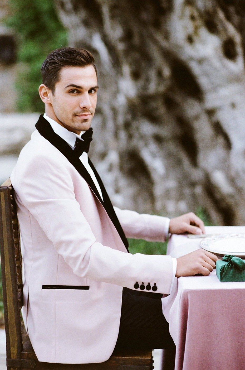 groom in soft pink and velvet jacket
