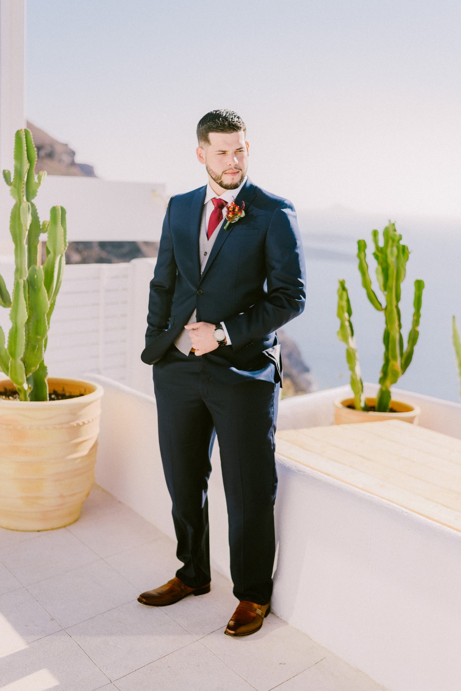 formal groom style with red tie and light grey vest