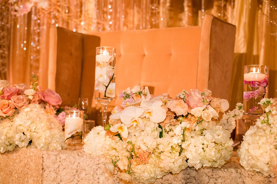 Lavish sweetheart table covered in flowers
