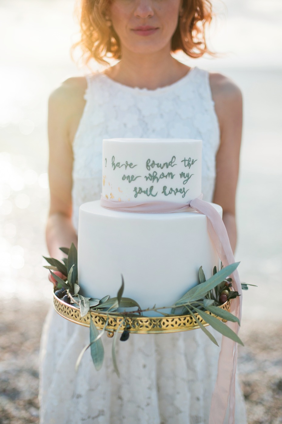 White wedding cake with love quote