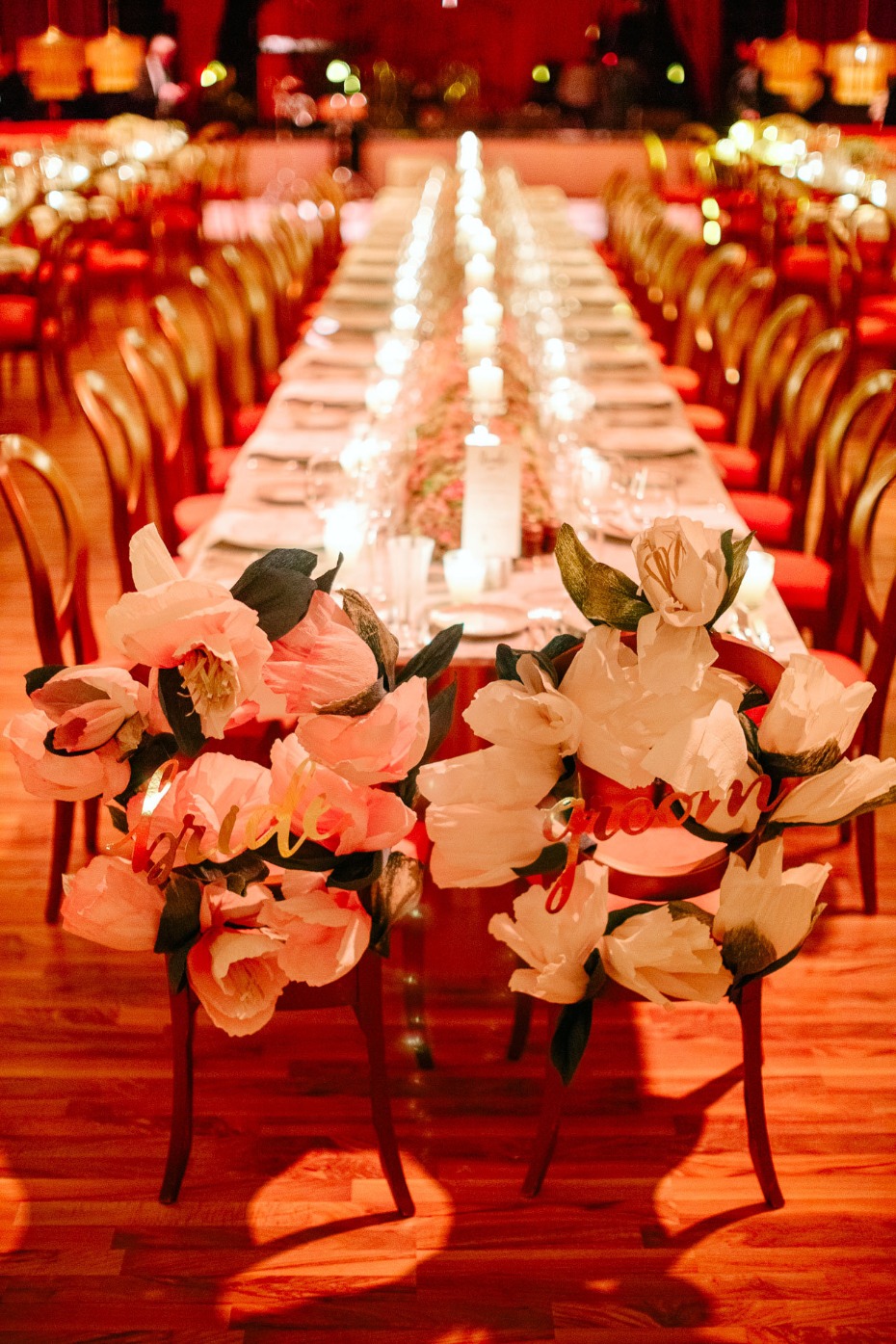 bride and groom wedding seats with giant paper flowers