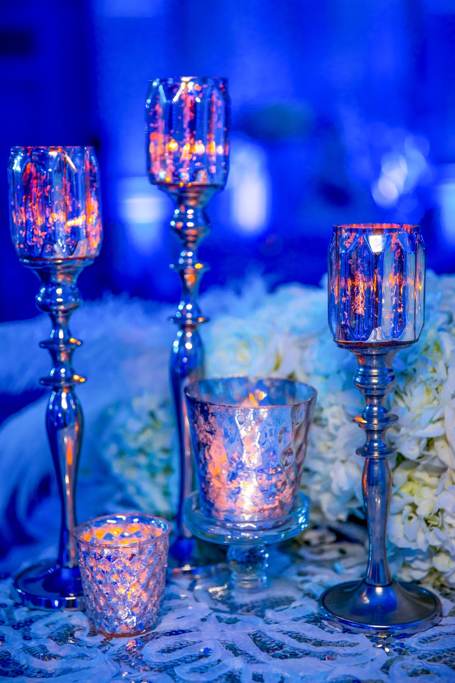 Elegant blue table with candles and floral arrangement